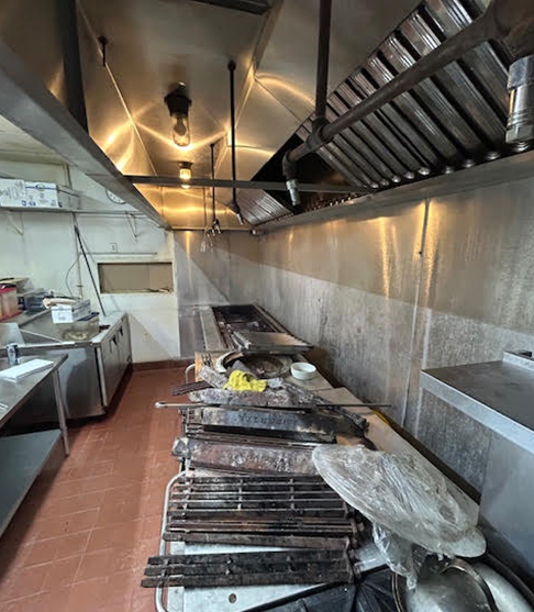 Firefighter inspecting fire extinguisher during home safety check by Freedom Fire Inspectors.