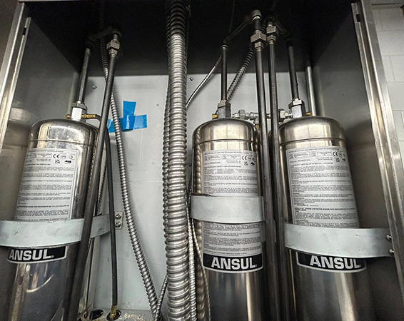 Firefighter inspecting fire extinguisher, Freedom Fire Inspectors home services.