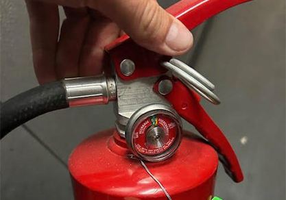 Freedom Fire Inspectors performing fire safety inspection of equipment.